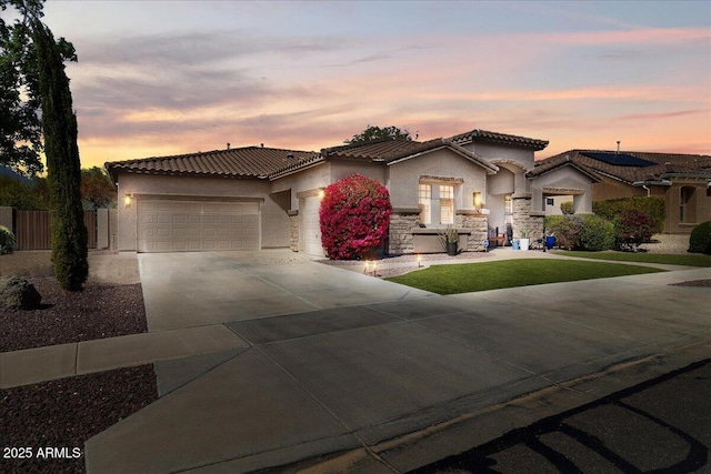 mediterranean / spanish-style home featuring a garage, driveway, a tile roof, fence, and stucco siding