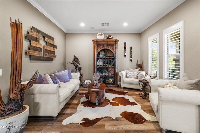 living area featuring recessed lighting, wood finished floors, and crown molding