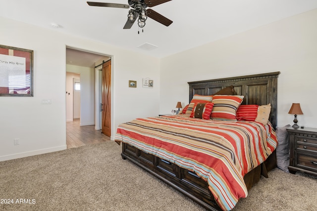 bedroom featuring light colored carpet and ceiling fan