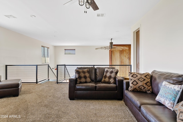 carpeted living room with ceiling fan