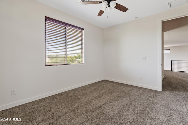 carpeted spare room with ceiling fan