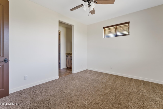 empty room with ceiling fan and carpet floors