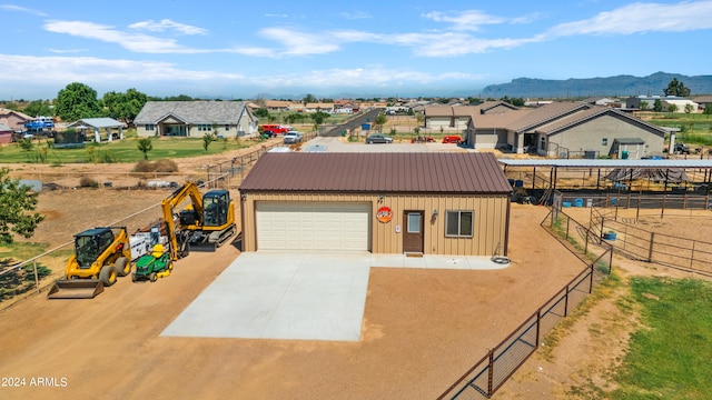 view of front of house with an outdoor structure, a garage, and a mountain view