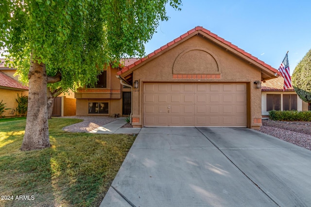 view of front of house featuring a front yard and a garage