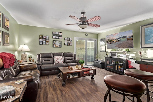 living room featuring ceiling fan and wood-type flooring