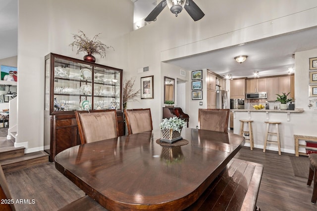 dining space featuring ceiling fan and dark hardwood / wood-style flooring