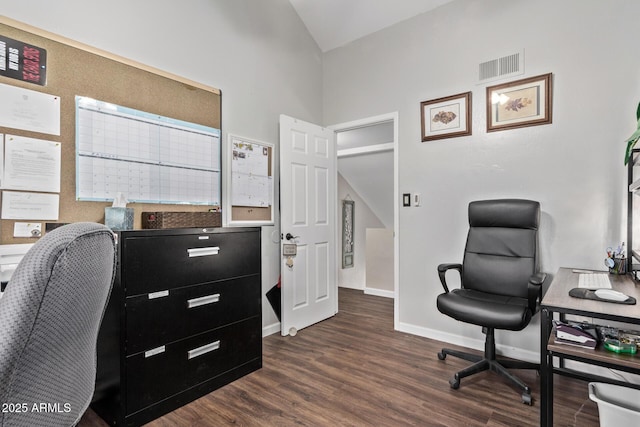 office space with lofted ceiling and dark wood-type flooring