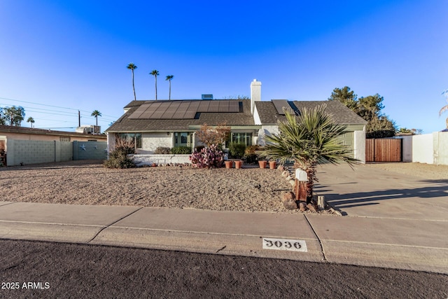 single story home featuring solar panels