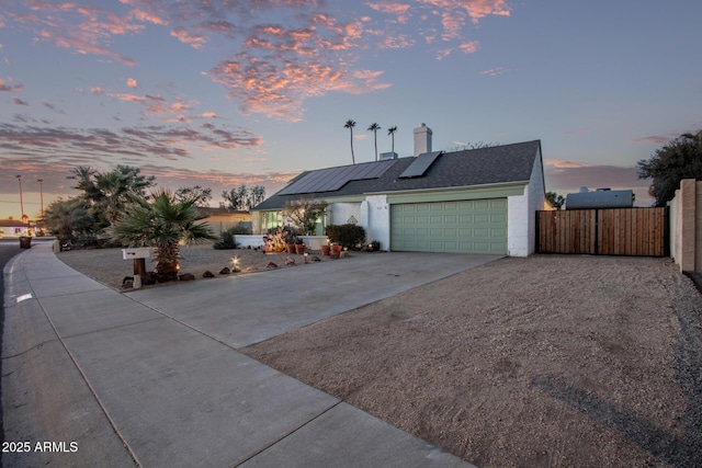 view of property with solar panels and a garage