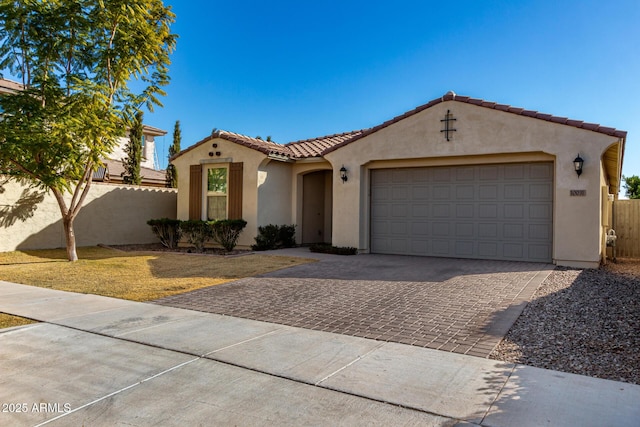 mediterranean / spanish-style house with a garage