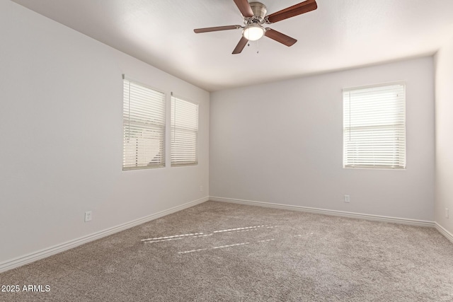 carpeted spare room featuring ceiling fan