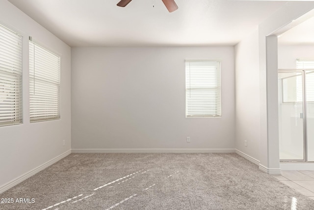 carpeted spare room with ceiling fan