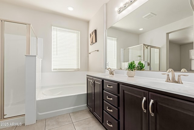 bathroom featuring vanity, tile patterned flooring, and shower with separate bathtub