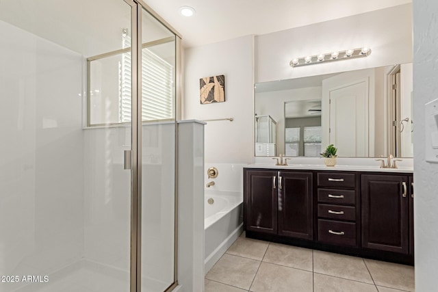 bathroom with tile patterned floors, vanity, and independent shower and bath