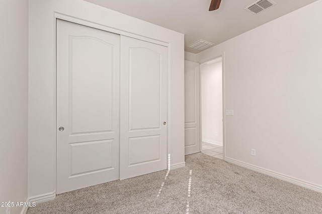 unfurnished bedroom with a closet and ceiling fan