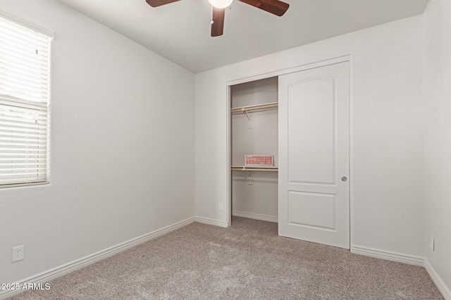 unfurnished bedroom with light carpet, a closet, and ceiling fan