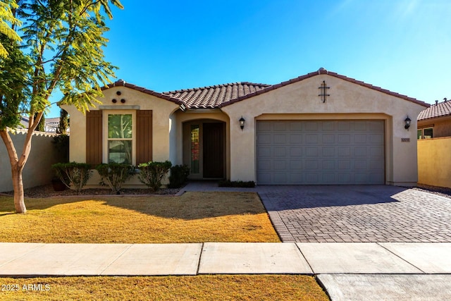 mediterranean / spanish-style home with a garage