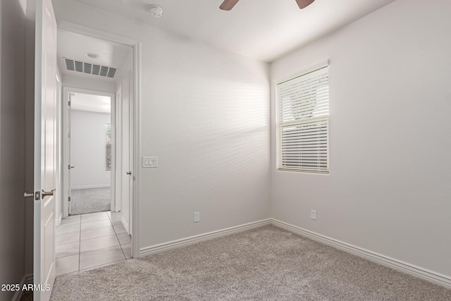 carpeted spare room featuring ceiling fan