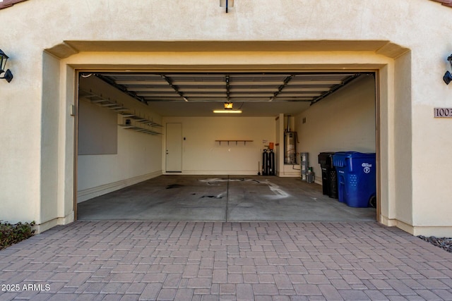 garage featuring water heater and a garage door opener