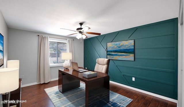 office space featuring dark wood-type flooring, baseboards, and ceiling fan