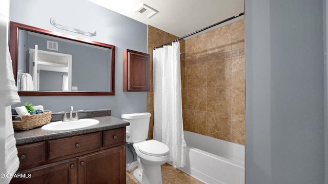 bathroom with vanity, toilet, visible vents, and tile patterned flooring