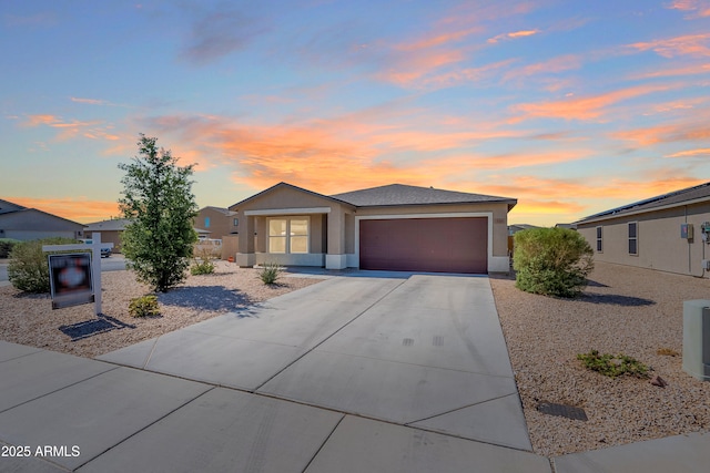 359 E Watson Pl, Casa Grande, AZ 85122 - view of front of property with an attached garage, concrete driveway, and stucco siding
