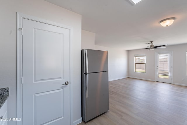 359 E Watson Pl, Casa Grande, AZ 85122 - kitchen with freestanding refrigerator, ceiling fan, light wood-style floors, and baseboards
