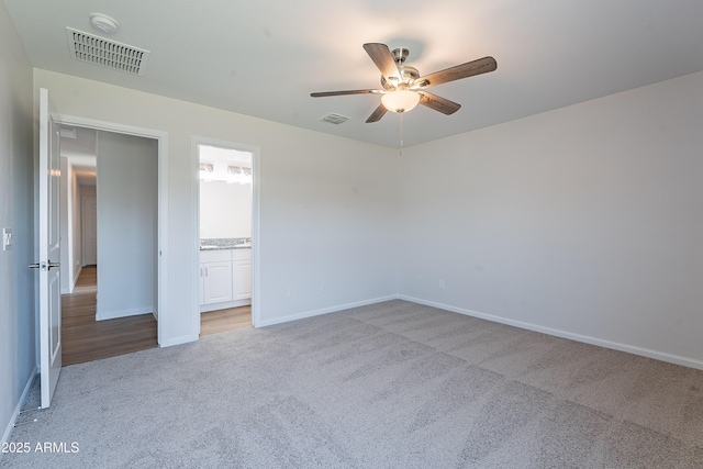 359 E Watson Pl, Casa Grande, AZ 85122 - unfurnished bedroom with carpet, baseboards, ensuite bath, and a ceiling fan