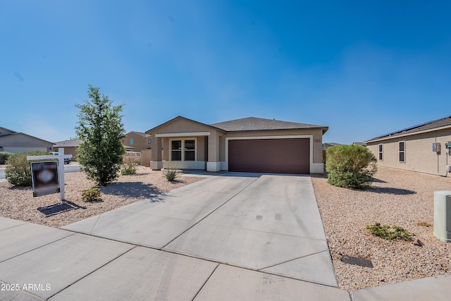 359 E Watson Pl, Casa Grande, AZ 85122 - view of front of property featuring an attached garage, concrete driveway, and stucco siding