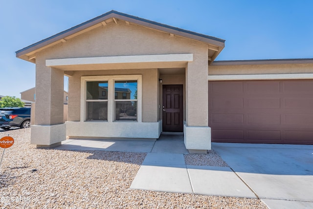 359 E Watson Pl, Casa Grande, AZ 85122 - view of front facade featuring stucco siding, concrete driveway, and a garage