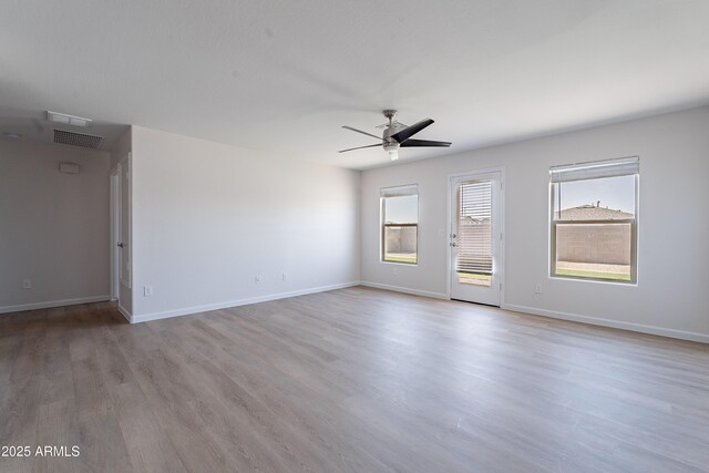 359 E Watson Pl, Casa Grande, AZ 85122 - unfurnished room featuring a ceiling fan, wood finished floors, and baseboards