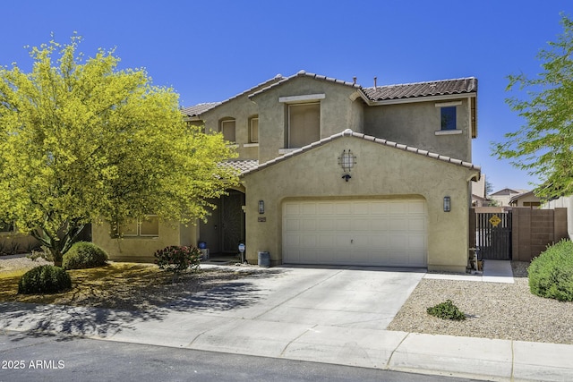 view of front of house with driveway, a tile roof, a garage, fence, and stucco siding