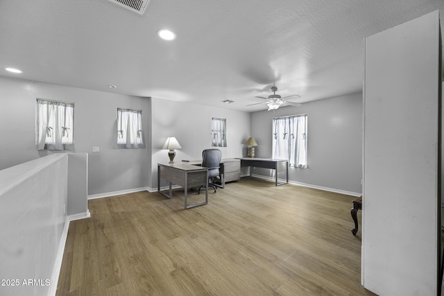 office space with baseboards, recessed lighting, ceiling fan, and wood finished floors