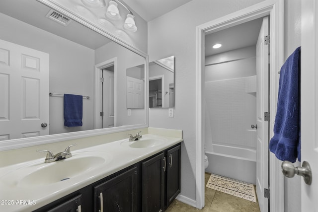 full bathroom with double vanity, toilet, visible vents, and a sink
