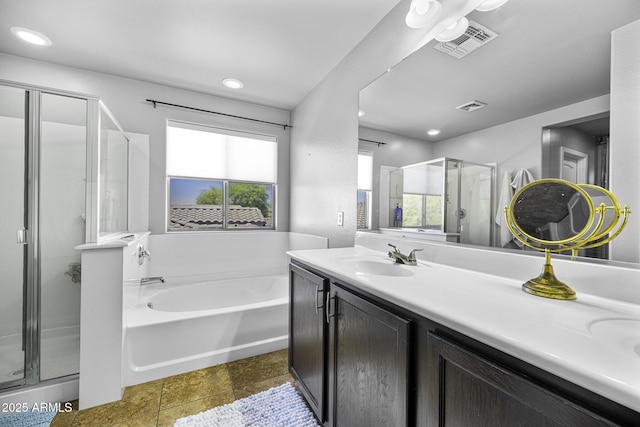 full bath featuring stone finish floor, a garden tub, visible vents, a shower stall, and vanity