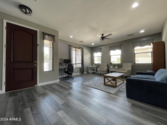 unfurnished living room with ceiling fan and hardwood / wood-style floors