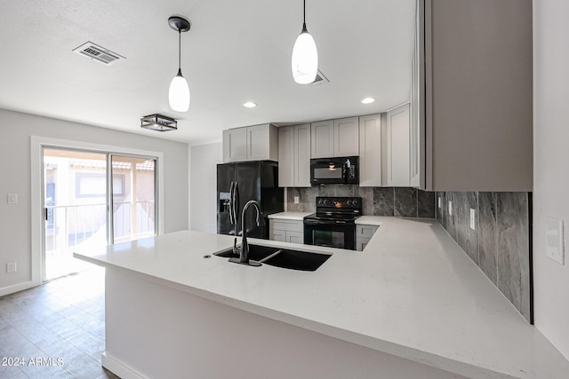 kitchen featuring a peninsula, black appliances, visible vents, and light countertops