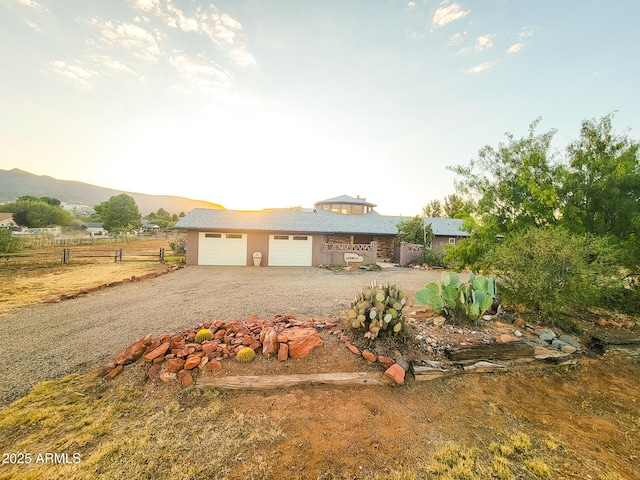 view of front of house featuring a garage and a mountain view