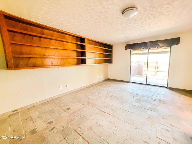 unfurnished room featuring a textured ceiling