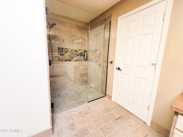 bathroom with a shower with door