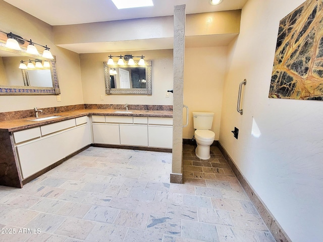 bathroom with toilet and vanity