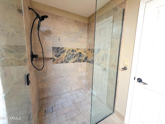 bathroom with a shower with door