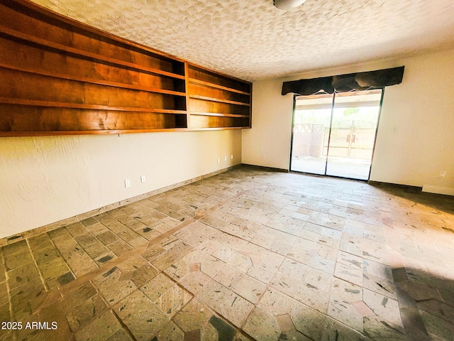 unfurnished room with a textured ceiling