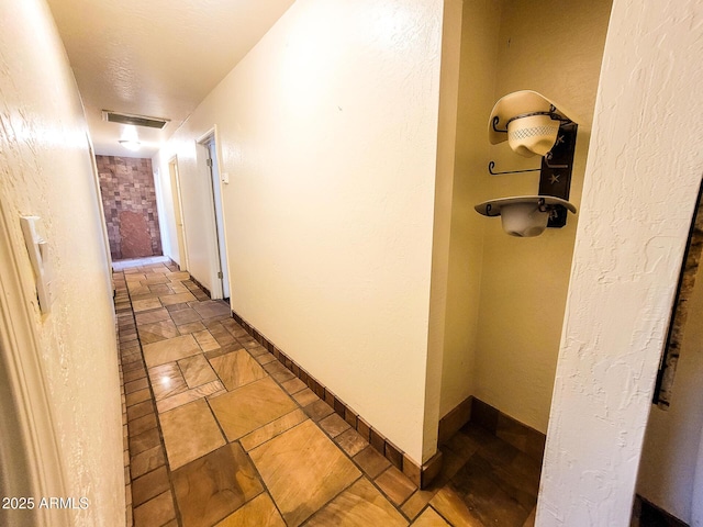 hallway with a textured ceiling