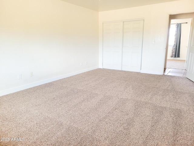 unfurnished bedroom featuring a closet and carpet