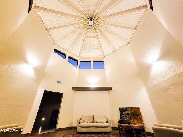 living room featuring a towering ceiling