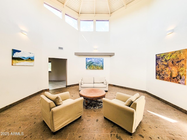 living room featuring a towering ceiling