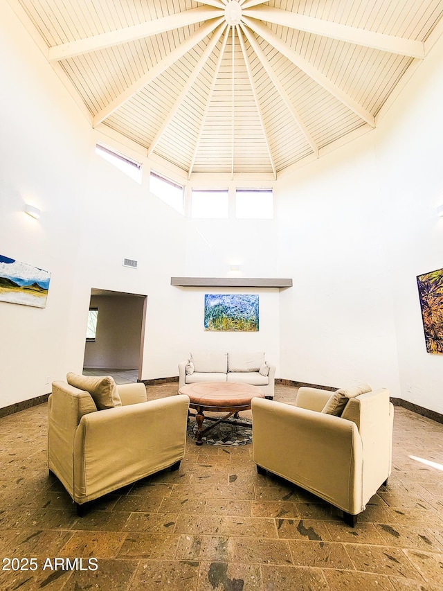 living room with high vaulted ceiling