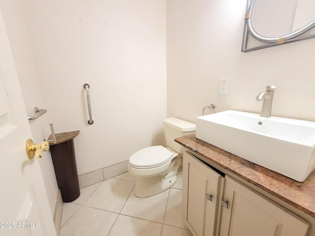 bathroom featuring vanity, toilet, and tile patterned flooring