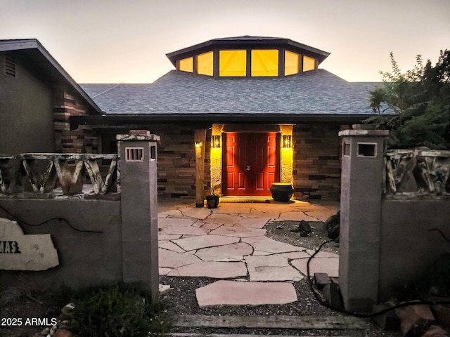 view of back house at dusk